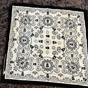 100% cotton bandanna black and white with skulls and paisley.